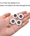 25mm diameter bearing steel shower door wheels with nylon rollers and stainless steel screws on a hand