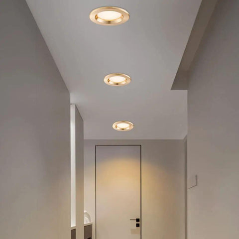 Top Shelf 9 Pack 3 Inch LED Recessed Downlights With Sleek Baffle Trim illuminating a hallway with warm glow.