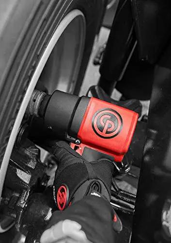 Shop Tested 3/4 Inch Air Impact Wrench pumping out 1400 Ft Lbs mean torque in use on a truck wheel with black and red design.