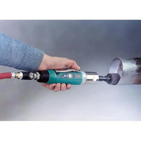 A hand holding a Badass One Horsepower Straight Line Air Die Grinder Pumping Twenty Thousand Rpm with rear exhaust polishing metal.