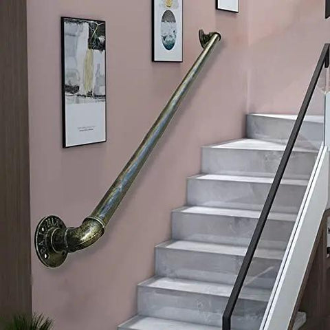 Heavy Duty Badass Wrought Iron Pipe Stair Handrail For Indoor Outdoor Use Rock Solid Wall Mount Banister For Decks Porches And Basements With Durable Bronze Finish mounted on a wall beside gray marble stairs.