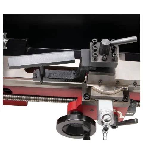Wood turning tool rest and spur center on mini/bench lathe, side view, height adjustable, metal gray.