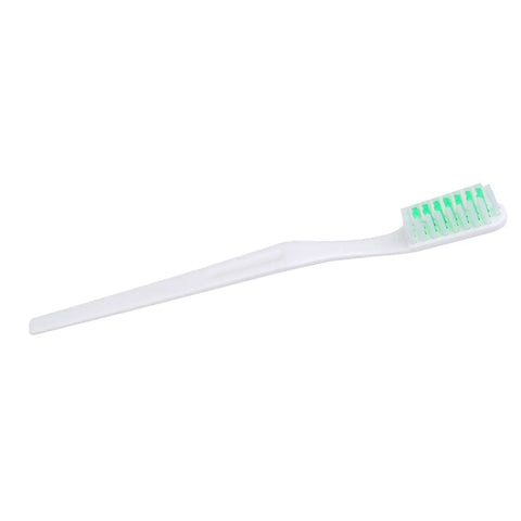 White toothbrush with green bristles on a plain background, ideal for daily dental hygiene routines.