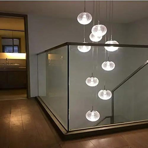 Modern Round Glass Ball Chandelier With Long Stair Pendant Light Featuring Heavy Duty Steel Frame And Premium Glass Orbs For Easy Ceiling Setup And Killer Room Glow illuminating a hallway with clear spheres.