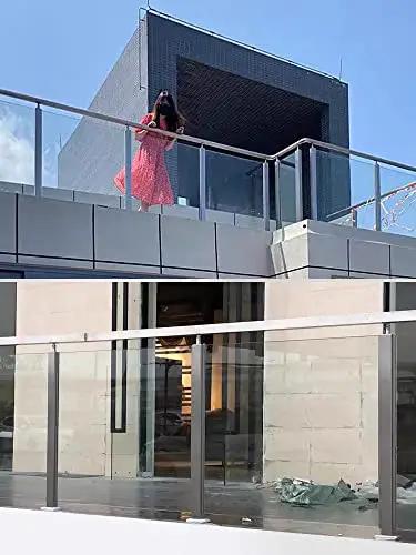 Solid 304 Stainless Steel Railing Post Kit For Decks And Staircases supporting glass panels on a modern balcony with a person. 