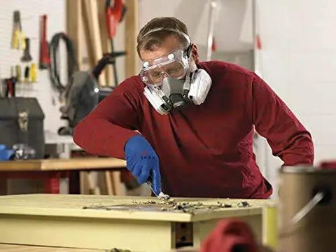 Built Tough Chemical Splash Safety Goggles With Anti Fog Vents And Impact Resistant Polycarbonate Lenses And Jobsite Approved Eye Protection For Hard Working Pros And Tradesmen Ready For Any Messy Task worn by a worker using a chisel.