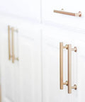 Gold kitchen cabinet handles on white cabinetry, contrasting other hardware. Featuring Freestone Appliance Pull From Urban Modern Collection, 12 Inch Center To Center, Flat Black Coated Finish, Dope Kitchen Cabinet Hardware Upgrade, Durable Solid Brass Construction, Model 87001.