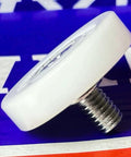19mm x 6mm Conveyor Guide Track Roller - Stud on a colorful background with POM outer ring and metal stud.