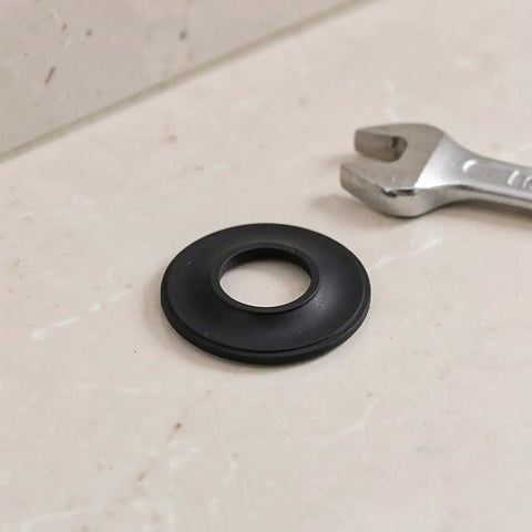 10pcs Rubber Bathtub Drain Stopper Washer Black Elastic Leak Seal, circular rubber gasket on marble surface with a wrench.