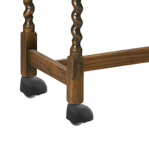 Four Piece Nylon Office Chair Wheels Silent Swivel Casters on wooden furniture legs for smooth movement.
