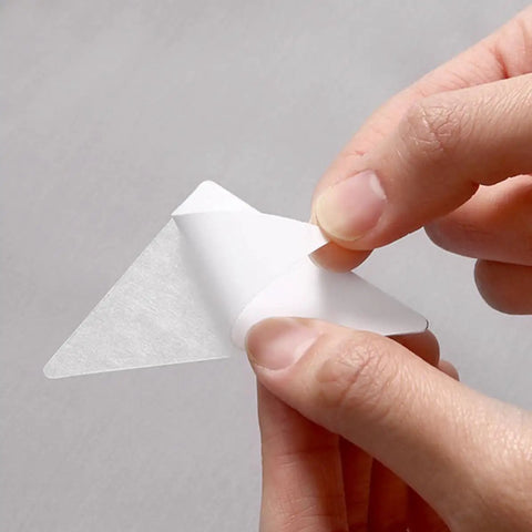 Premium White PVC Adhesive Collar Stays 240 Pack Shirt Collar protectors being peeled off for application on shirts.