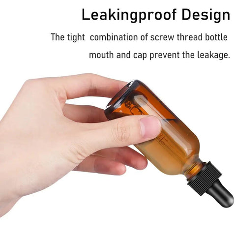 Two Pack Real Deal Amber Glass Dropper Bottles Two Oz with leakproof design held in hand, showcasing amber glass and silicone cap.