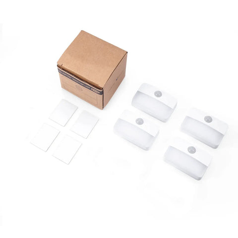 4 Pack Mini Motion Sensor Stair Lights Battery Powered Cordless LED Night Lights No Wires Easy Install 40 Lumens 3000K For Stairs Hallways Bathrooms Kitchens Cabinets Auto On When Motion Detected Up To 16 Feet, showing four lights and packaging