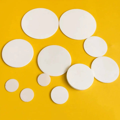 Lab Grade Boron Nitride Ceramic Round Disc With Ultra High Thermal Conductivity For Science Labs And Research Projects BN Disk 110mm Diameter 3mm Thick displayed on a yellow surface.