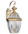 Lancaster Traditional Two Light Outdoor Wall Lantern In Polished Brass Finish No Fuss LED Upgrade Ready Classic Exterior Fixture For Porch Or Patio Weather Resistant Outdoor Lighting features clear beveled glass and a traditional design.