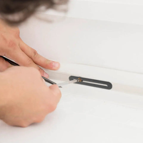 Hands installing 10-Pack Stainless Steel Adjustable Flat Mending Plates With Slot Holes For Furniture Repair on a white surface.