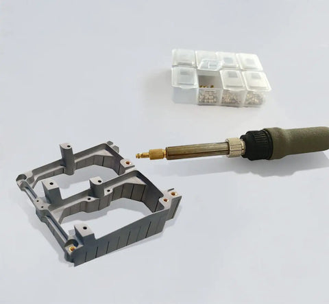 Heat Set Inserts For Plastic 3D Printing Kit With M2 M2.5 M3 brass inserts and a soldering iron next to a 3D printed frame