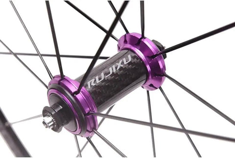 Close-up of carbon cassette hub in purple finish on road bike wheel set 700C 40mm double wall rims for fast acceleration.