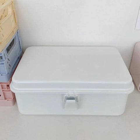 Heavy Duty Vintage White Metal Toolbox Featuring A Tight Snap Shut Locking Latch Tin Storage Case For Everyday Gear And Art Supplies Classic Secure Organizer Trunk on a table.