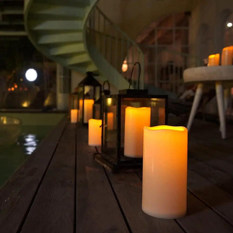 Outdoor Waterproof Flameless LED Pillar Candles Set 6 8 10 Inch with Remote and Timer by a poolside patio at night