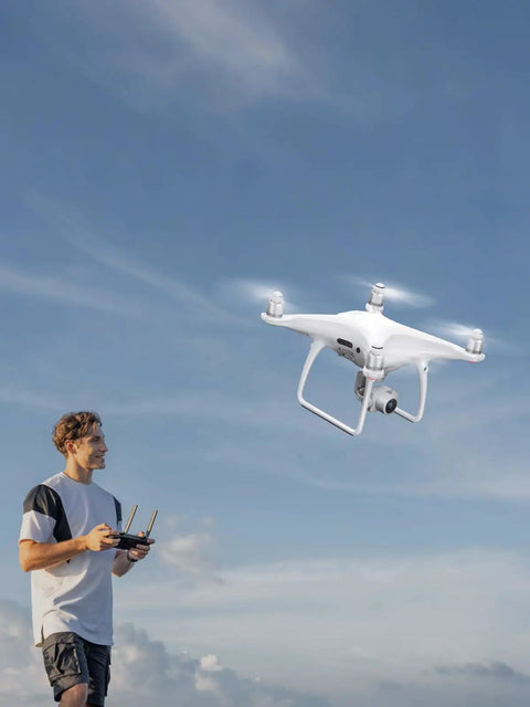 Man flying drone with Phantom 4 Pro Series Beefed Up Battery Replacement 5870mAh Intelligent Flight Battery Pack For DJI Phantom 4 Drones