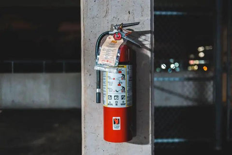 Rock Solid 5 Lb Abc Fire Extinguisher With Pressure Gauge And Wall Hook Ul Certified Dry Chemical Powder mounted on a grey wall.