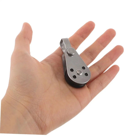Hand holding Beefy Heavy Duty Stainless Steel Pulley Block Set For Boats Kayaks And Yachts, Smooth Bearing Wheel For Rope And Cable