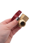 Hand holding Gas Connector Shut Off Angle Valve Five Eighth Inch OD Flare With Fifteen Sixteenth By Sixteen Thread To Three Quarter Inch