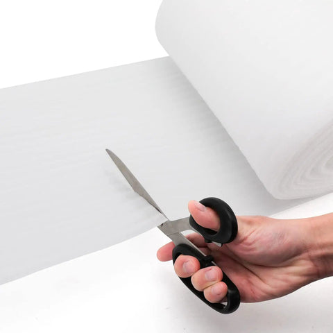 Keep Your Gear Tight And Damage Free On Any Move Or Haul This 12 Inch Wide By 33 Foot Long Foam Wrap Roll being cut with scissors.