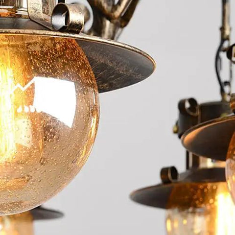 Close-up of Rustic Box Ceiling Pendant Light Badass Industrial Hanging Chandelier with amber glass and antique finish.