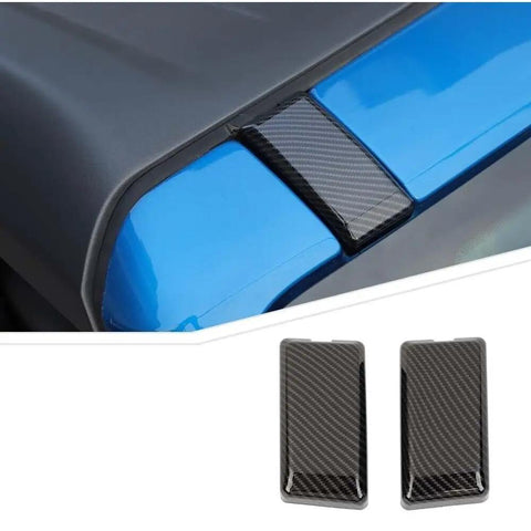 Slick Carbon Fiber Top Screws Protector Cover Trim Cap For 2021 Plus Vehicles on a blue surface showing sleek design and fit.