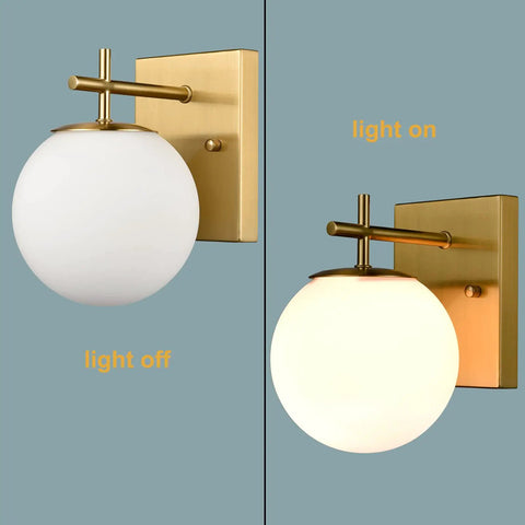 Gold Globe Wall Sconces Set of Two, Dope Brass Modern Vanity Lights With Milky White Glass Shades shown on and off, brushed brass finish