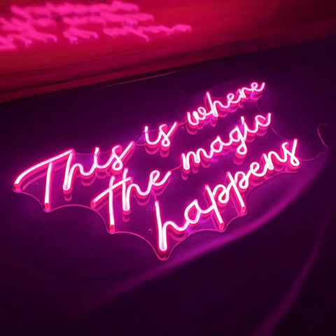 Where The Magic Happens Neon Sign Wall Decor 23 Inch LED Neon Light For Bedroom Bar Party Bright Yet Soft Glow Dimmable Night Light Perfect Gift For Her Bachelorette Easter Valentines Day, glowing pink neon sign on dark background.