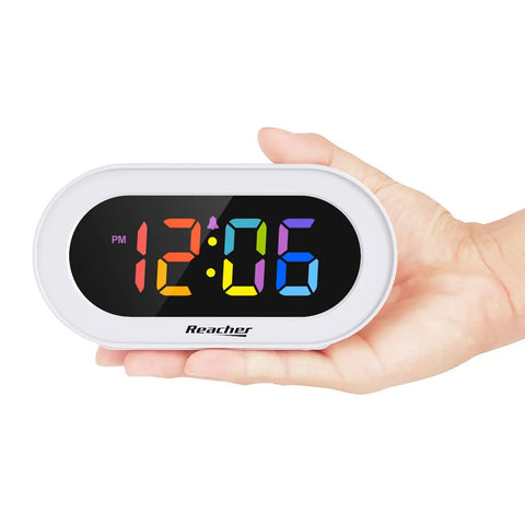 Snazzy Compact Colorful LED Digital Alarm Clock With Adjustable Brightness Dimmer And Volume Slider in hand showing time 12:06.