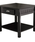Square black bedside table with drawer and shelf, paneled sides, brushed chrome pull, rustic modern accent piece
