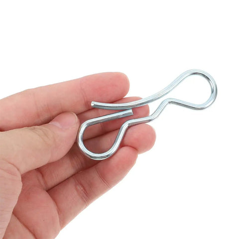 Hand holding a silver cotter pin from the Bow Tie Lock Cotter Pins And Deck Clip Fasteners Assortment Kit for heavy duty use.