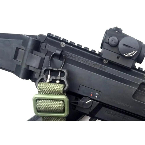 Game Changer Universal QD Wire Loop That Locks Dead Sure On 1.25 Inch Slings Mounts Plug And Play To Keymod Or Handguards For No Stress Instant Release In Sleek Black Finish mounted on tactical rifle with green sling.