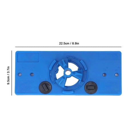 Blue ABS hole saw jig drilling guide with central cutter and two knobs, 22.5 cm by 9.5 cm.