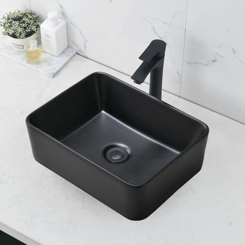 Modern black rectangular vessel sink with faucet on marble countertop