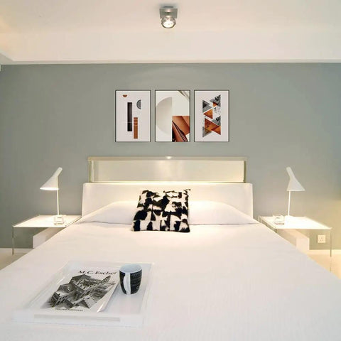 Bedroom with framed art hung using No Trace Picture Hangers For Concrete And Drywall 25 Pack Invisible Nail Hangers above bed