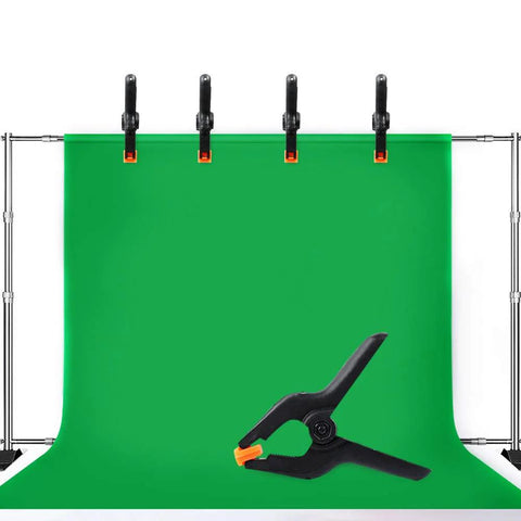 Front view of 10-pack 4.5-inch plastic spring clamps on a backdrop stand, green backdrop with black clamps and orange tips.