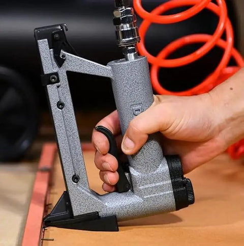 Beefy Pneumatic Picture Frame Nail Gun And Portable Air Stapler For Photo Mirror Framing Heavy Duty Handheld Pin Nailer in use.
