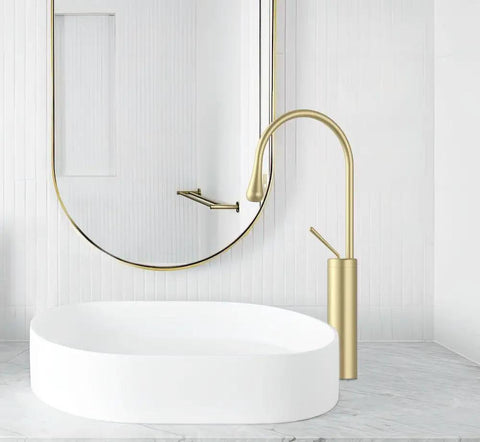Brushed Gold Vessel Sink Faucet With High Arc, Single Lever Handle, shown on marble vanity with oval sink