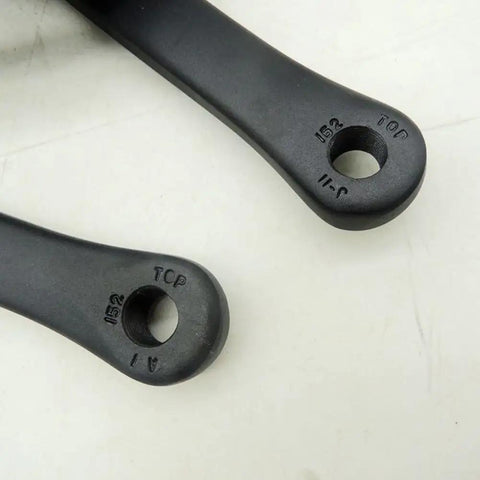 Close-up of 152mm Square Taper Bike Crankset With 32T Chainring, Aluminum Alloy, arm details, square hole for bottom bracket.