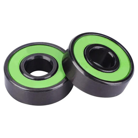 Premium Chrome Steel Skateboard Bearings With Extended Inner Ring For Zero Wobble And Razor Sharp Alignment, showing green rubber seals.