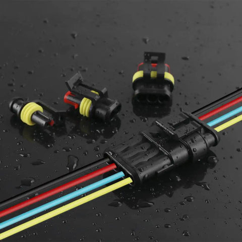 Heavy Duty 384Piece Waterproof Automotive Wire Connector Kit with 1 2 3 4 Pin Plugs on wet surface showing pin connection