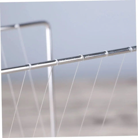 Close-up of Newton Pendulum Ball Desk Decor Stainless Steel Kinetic Art strings showing delicate structure and design.