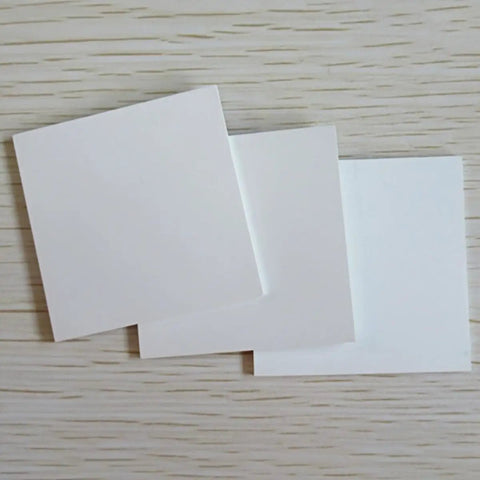 Lab Grade Boron Nitride Ceramic Square Sheet 99 Percent Purity, 3 Millimeter Thick By 40 By 40 Millimeters, One Piece, shown on wood surface
