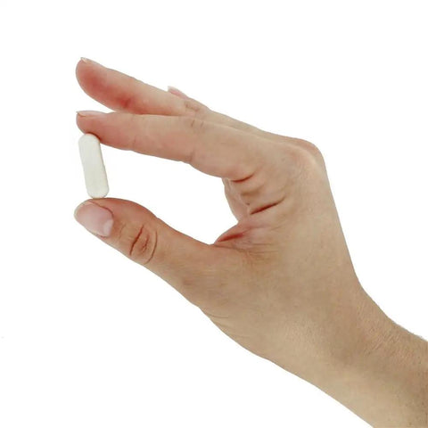 Hand holding a tablet of Calcium Orotate Capsules Dietary Supplement For Bone Health Made In The USA 100 Count For Everyday Support
