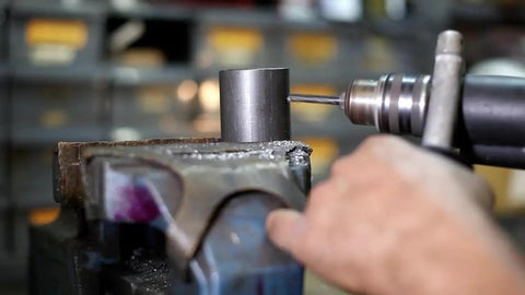 Man using 7/8 Inch Reduced Shank High Speed Steel Drill Bit With 1/2 Inch Shank DWDRSD Series to drill metal in workshop